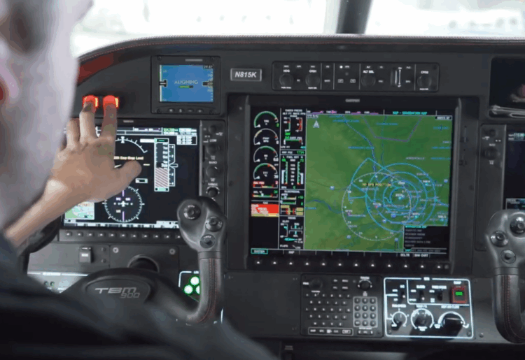 Service man booting up a Garmin avionics system